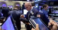 FILE - In this Sept. 18, 2014, file photo, trader Damian Bagarozza, center, works on the floor of the New York Stock Exchange. On Sept. 18, the U.S. stock market was at a record high after a relatively uneventful summer. Long-term interest rates were heading higher, a sign that investors expected steady growth in the U.S. economy. (AP Photo/Richard Drew, File)